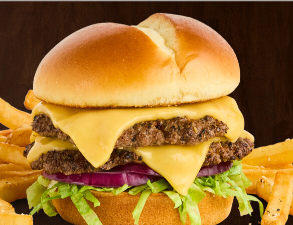 $6.99 American Smashed Burger  Two smashed beef patties topped with American cheese, onion, and lettuce. Served with fries or tots.